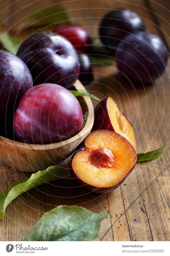 Fresh plums with leaves Fruit Nutrition Vegetarian diet Diet Bowl Summer Table Autumn Leaf Wood Juicy Brown Plum Purple Raw Mature agriculture sweet vitamins