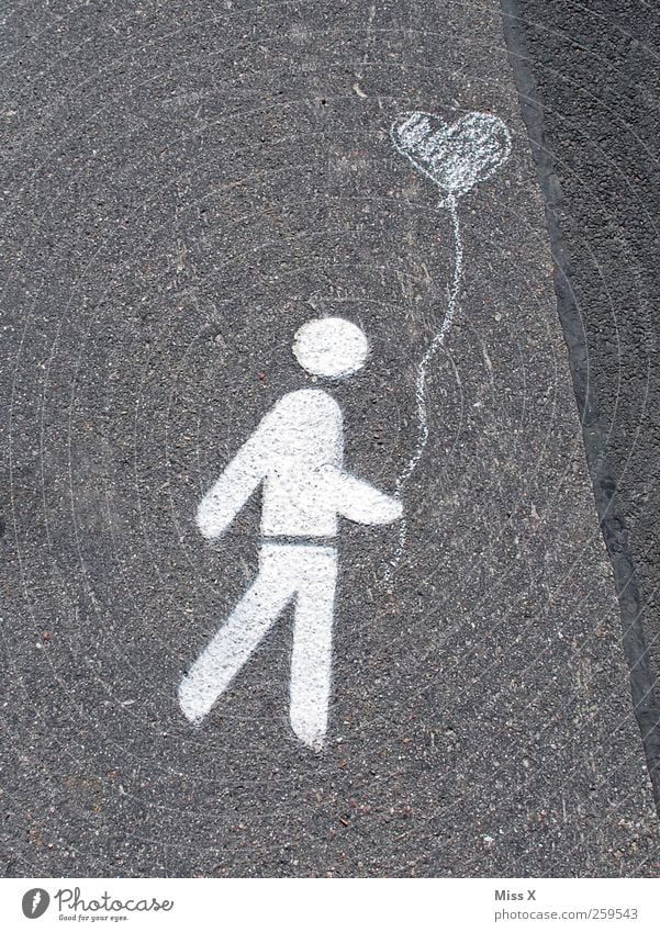 Heart on the street Man Adults 1 Human being Street Sign Signs and labeling Walking Love Infatuation Romance Balloon Colour photo Subdued colour Exterior shot