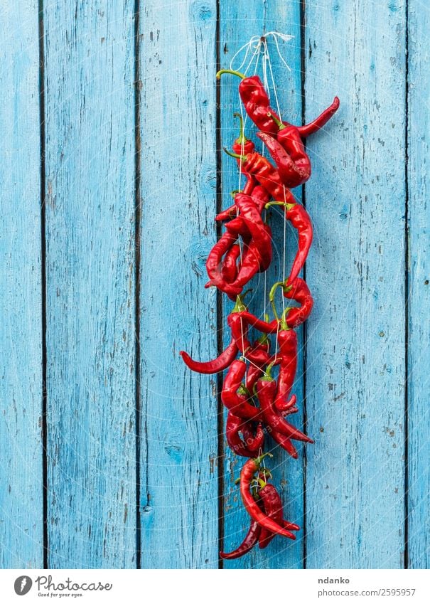 red raw ripe hot chili peppers Vegetable Herbs and spices Rope Wood Eating Fresh Hot Natural Blue Red Colour Hanging food Ingredients Spicy seasoning paprika