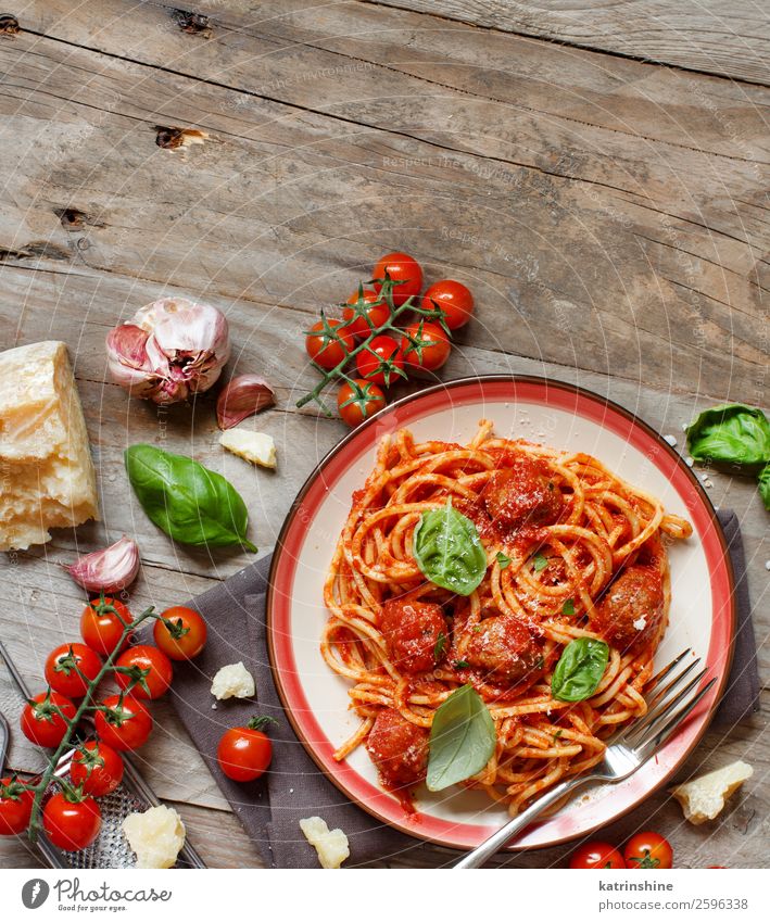 Pasta with tomato sauce and meatballs Meat Cheese Herbs and spices Lunch Dinner Plate Bowl Fork Table Dark Fresh Green Red Black Tradition pasta Basil Spaghetti