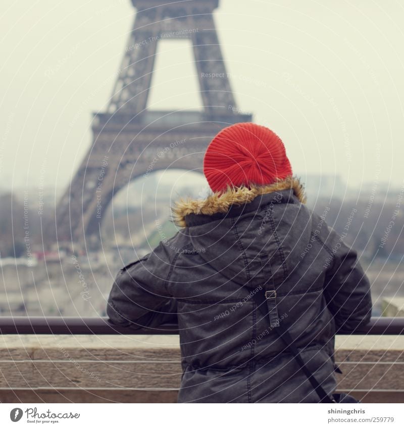 bonjour Woman Adults 1 Human being 45 - 60 years Bad weather Paris Tourist Attraction Eiffel Tower Cap Looking Stand Travel photography Vantage point Orange