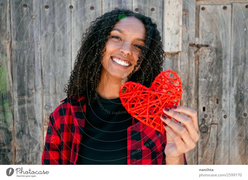 Beautiful young woman holding a red heart Lifestyle Style Joy Hair and hairstyles Human being Feminine Young woman Youth (Young adults) Woman Adults 1