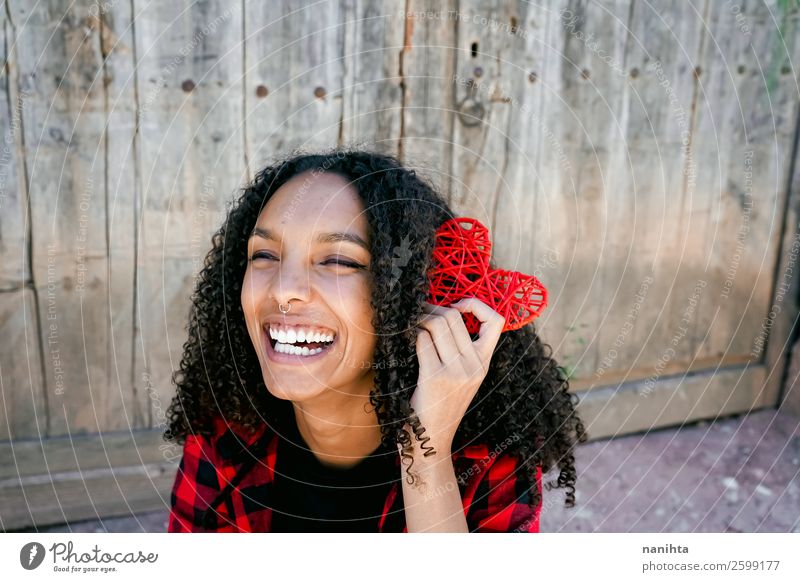 Beautiful young woman holding a red heart Lifestyle Style Joy Hair and hairstyles Healthy Wellness Human being Feminine Young woman Youth (Young adults) Woman