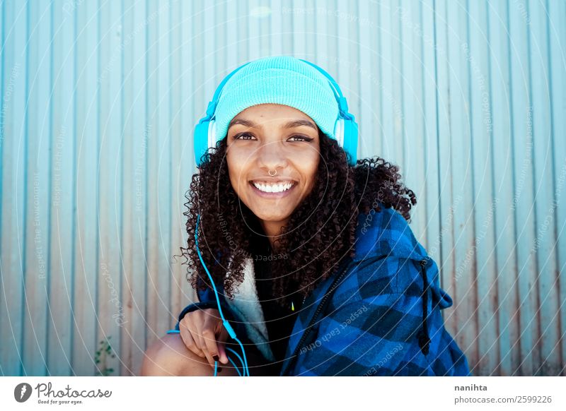 Young woman listening to music Lifestyle Style Hair and hairstyles Leisure and hobbies Winter Music Headset Technology Entertainment electronics Human being