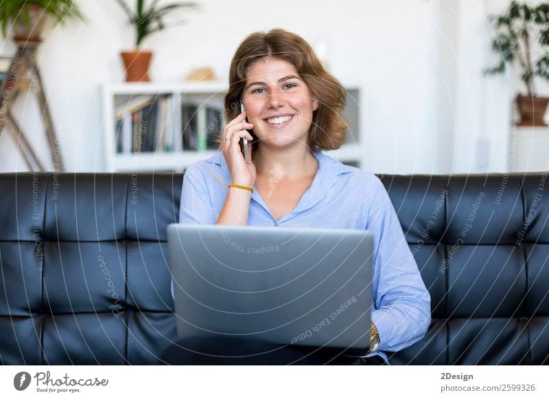 Entrepreneur woman wearing blue shirt working with a laptop sitting on a couch at home Shopping Happy Beautiful Sofa School Study Academic studies