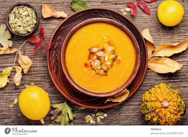 Autumn pumpkin soup food vegetable autumn dinner squash bowl vegetarian healthy meal yellow traditional cream fresh creamy tasty rustic cuisine eating seed