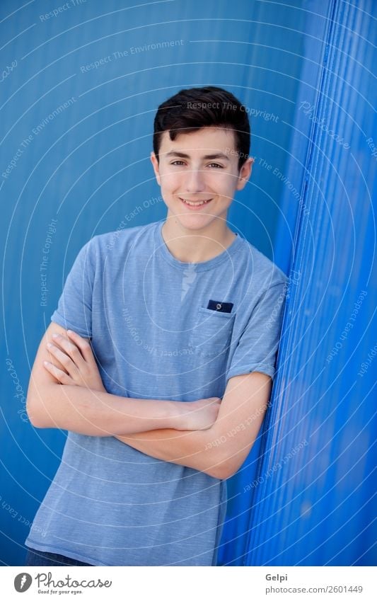 Portrait of a teenager rebellious man with a blue background Lifestyle Style Happy Beautiful Face Human being Boy (child) Man Adults Youth (Young adults)