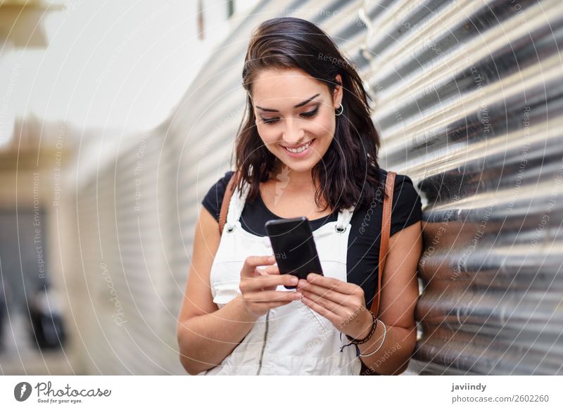 Smiling girl using with her smart phone outdoors Happy Beautiful Hair and hairstyles Telephone PDA Technology Human being Feminine Young woman