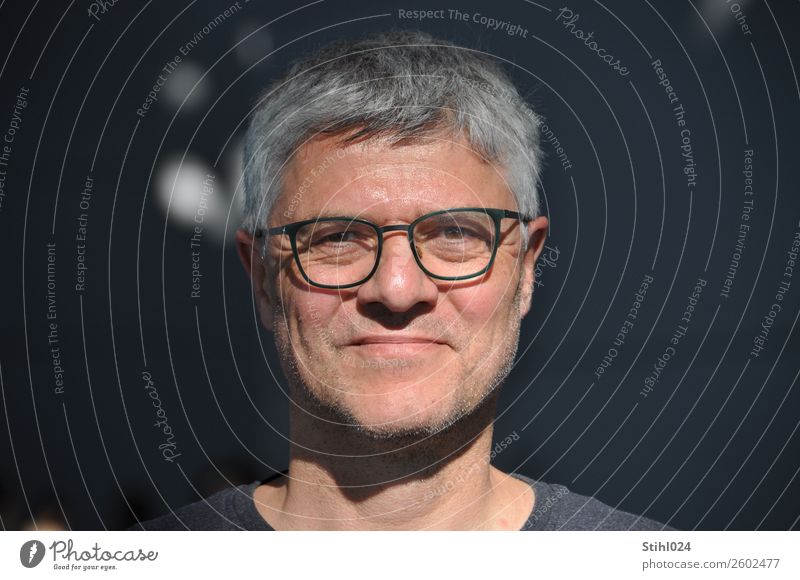 grey man in his fifties with glasses in the light in front of a dark background Masculine Man Adults Face 1 Human being 45 - 60 years Eyeglasses Gray-haired