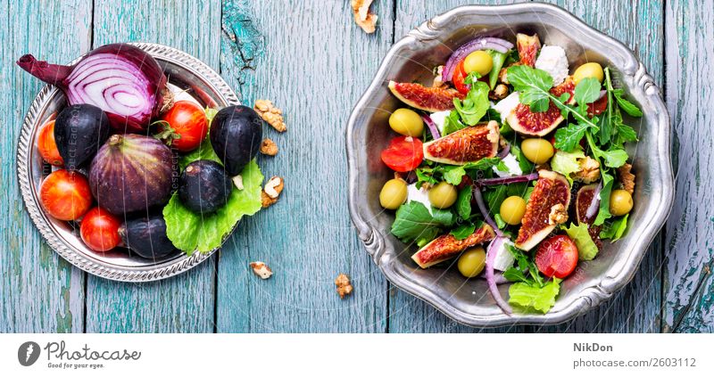 Dietary salad with figs green healthy fresh food cheese fruit organic arugula plate diet vegetable vegetarian ripe summer raw leaf autumn natural nut dieting