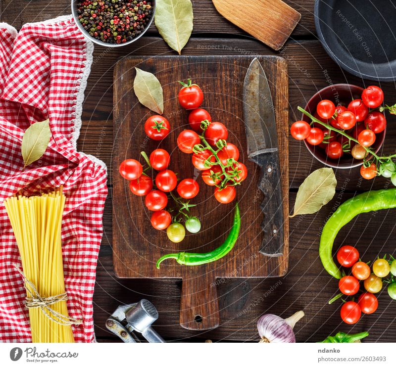 spaghetti and red cherry tomatoes Vegetable Dough Baked goods Dinner Table Wood Fresh Yellow Red pasta food background Raw Spaghetti Tomato cooking Cherry