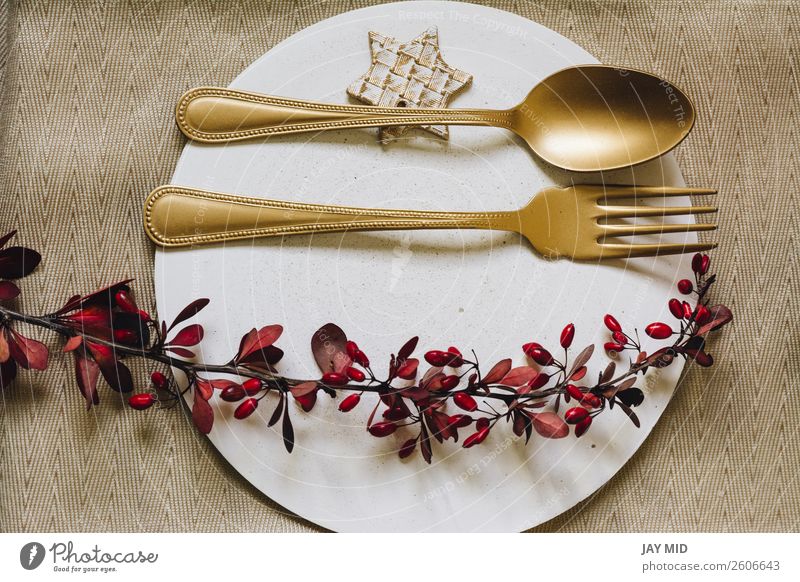 Holiday Gold place setting plate with fork and golden spoon. Dinner Plate Fork Spoon Elegant Winter Decoration Table Restaurant Feasts & Celebrations