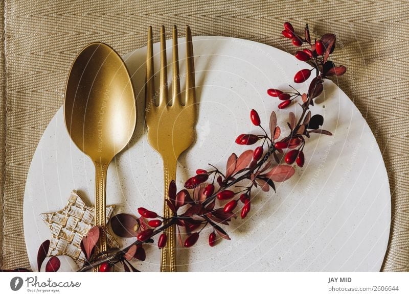 Holiday Gold place setting plate with fork and golden spoon. Dinner Plate Fork Spoon Elegant Winter Interior design Decoration Table Event Restaurant