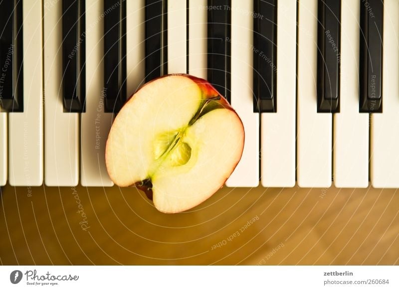 Piano on half apple Food Apple Organic produce Vegetarian diet Leisure and hobbies Playing Music Art Keyboard Fresh Senses Half Tone Vitamin wallroth