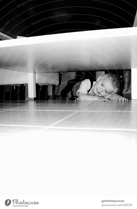 Underground Child Table White Flashy Narrow Flat Search Find Boy (child) Floor covering Tile Bright Lamp Hide Lie Looking Black & white photo Table edge