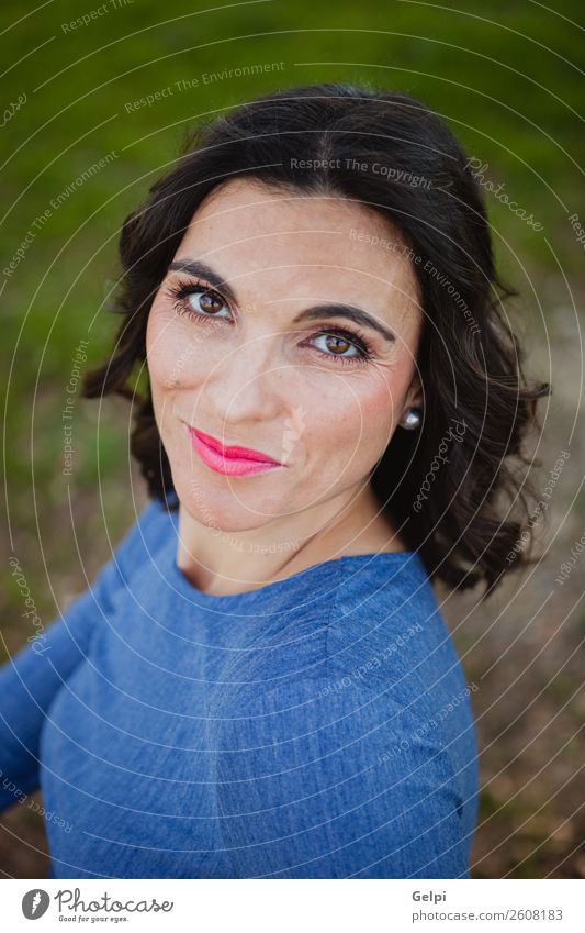 Woman Sitting On The Park Background With White Flowers A Royalty