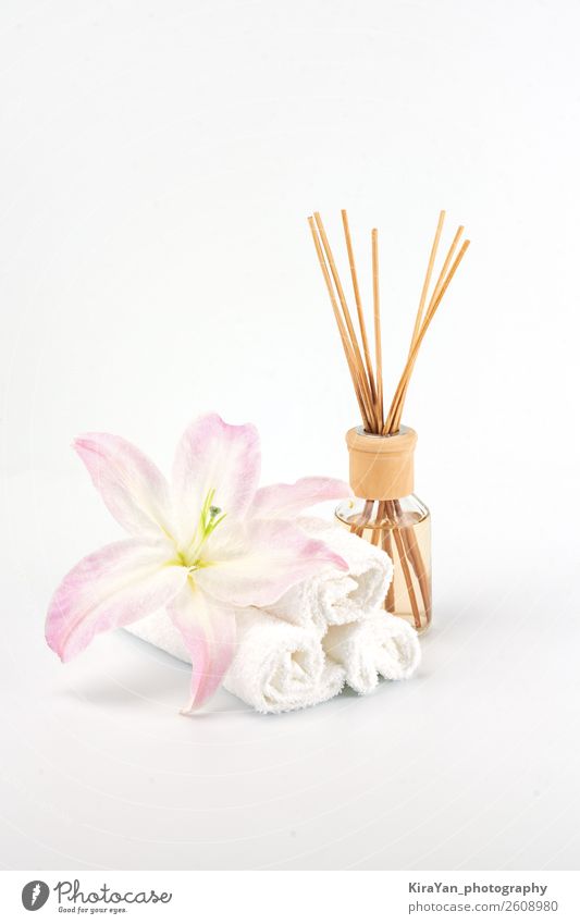 Spa decoration with pink lily, white towels and aroma oil Bottle Luxury Beautiful Body Skin Cosmetics Medical treatment Wellness Relaxation Meditation Massage