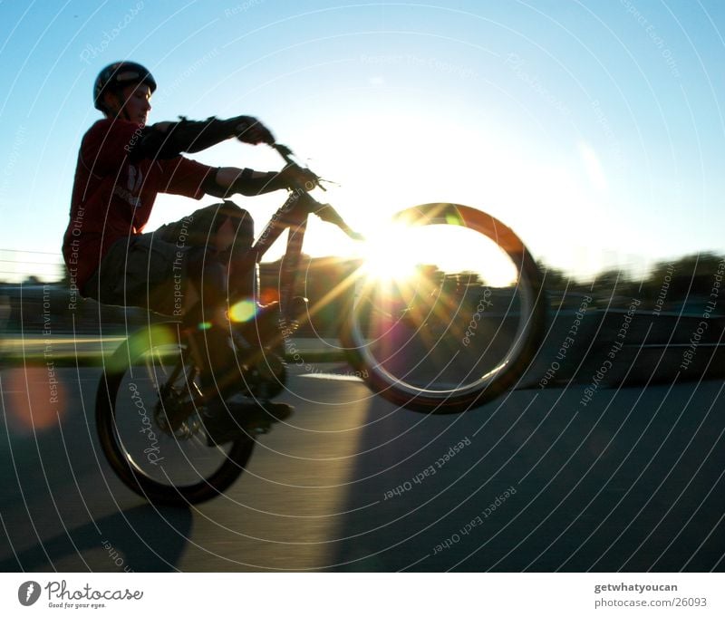 When back light breaks in the bike Bicycle Light Sports ground Wheel Dark Helmet Extreme sports Sky manual Bright Sun Evening lens effect