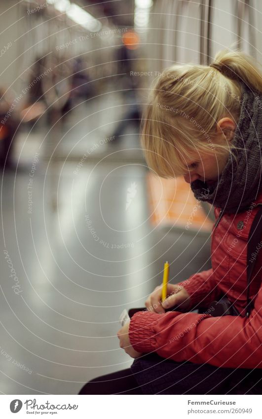 In the subway. Feminine Young woman Youth (Young adults) Woman Adults 1 Human being 18 - 30 years Leisure and hobbies Underground Piece of paper Notebook