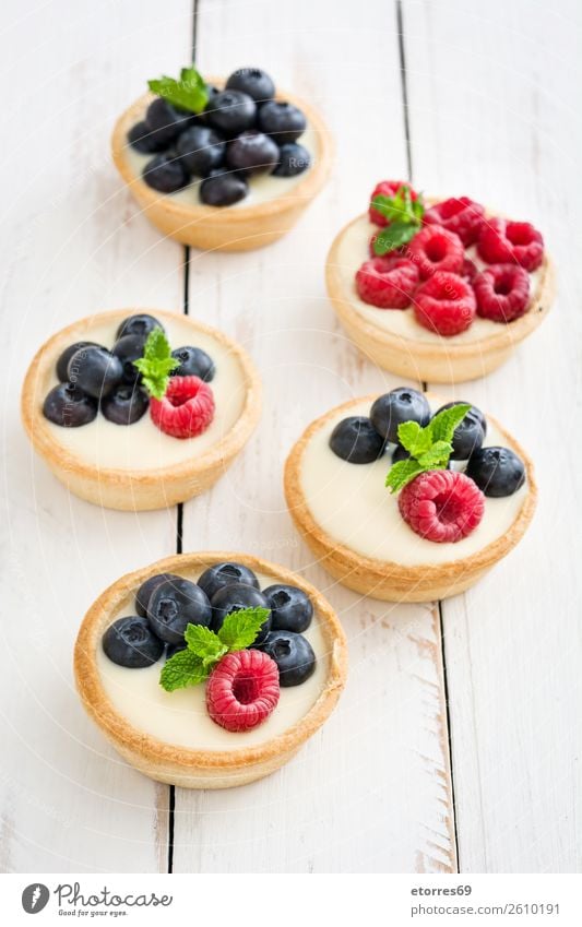 Delicious tartlets with raspberries and blueberries Tartlet Blueberry Raspberry Fruit Dessert Food Healthy Eating Food photograph Dish Cream custard Snack
