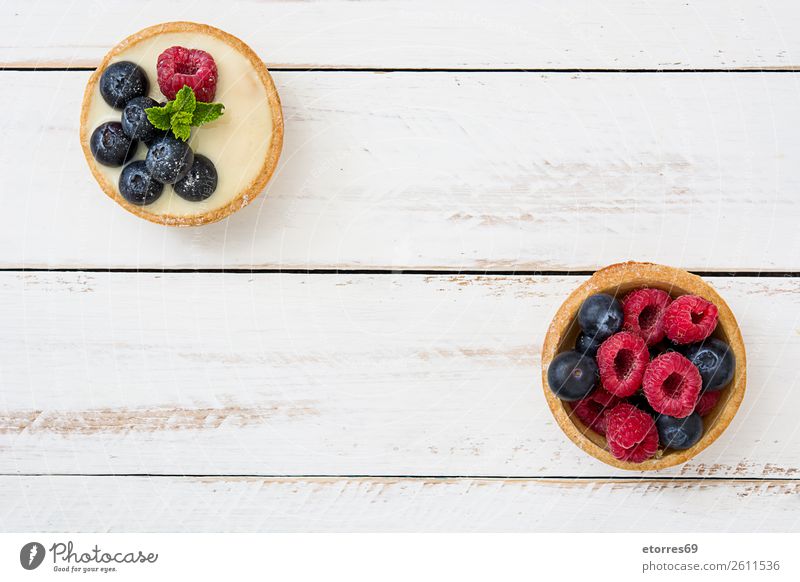 Delicious tartlets with raspberries and blueberries Tartlet Blueberry Raspberry Fruit Dessert Food Food photograph Cream custard Snack glazed Baked goods