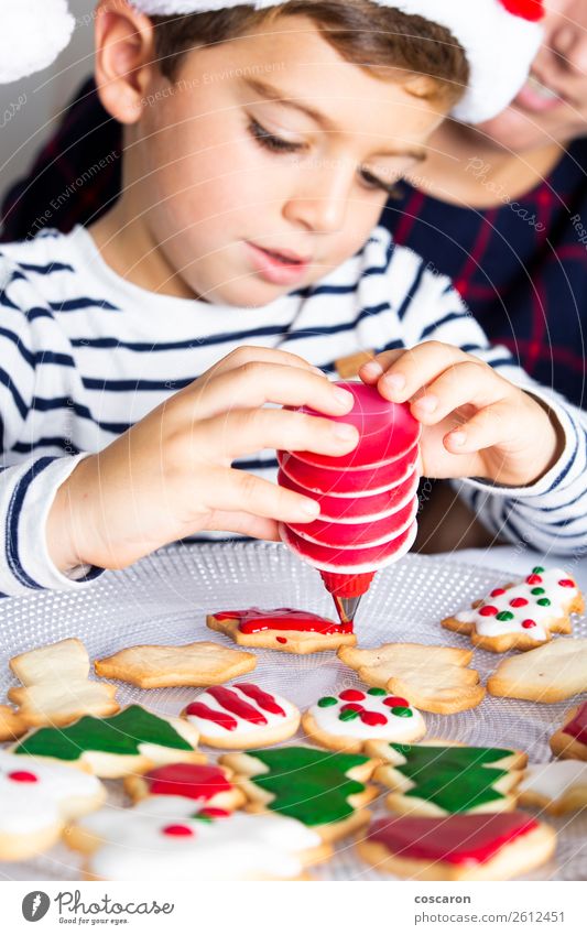 Little kid decorating Christmas biscuits at Christmas day Dough Baked goods Dessert Candy Joy Happy Winter Winter vacation Decoration Table Kitchen