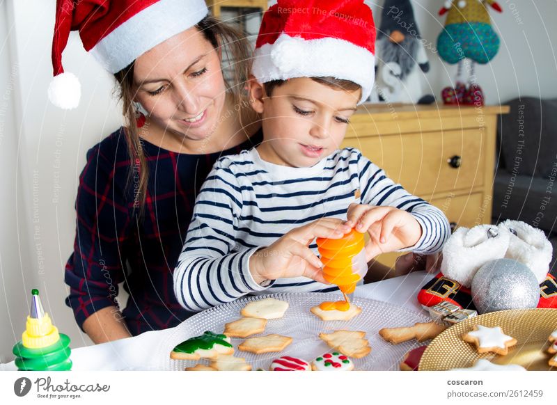 Mother and son decorating Christmas biscuits at home Food Cake Dessert Candy Lifestyle Joy Happy Beautiful Winter House (Residential Structure) Decoration