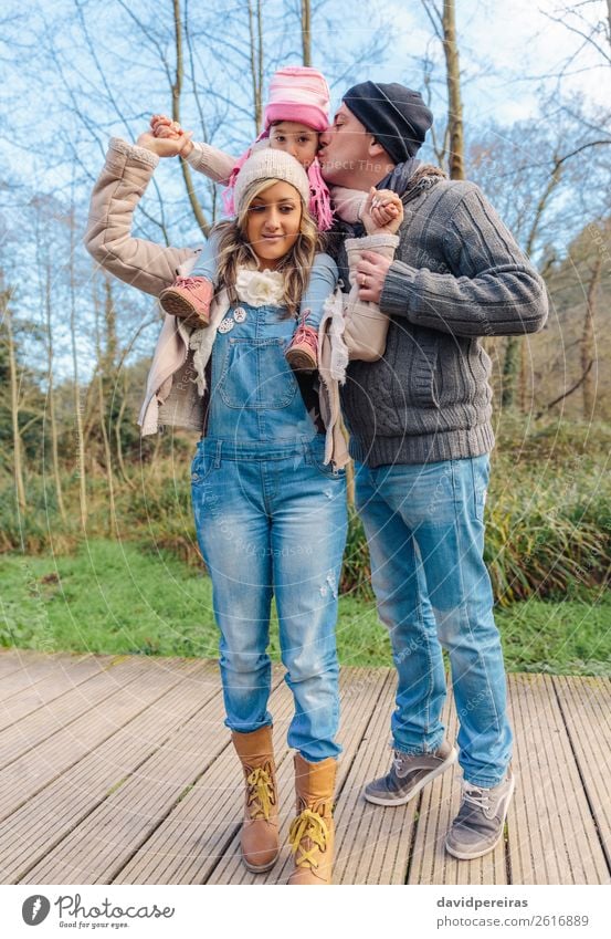 Happy mother giving her son a piggyback ride in the city stock photo