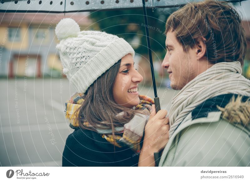 Young couple embracing and laughing outdoors under umbrella Lifestyle Happy Beautiful Winter Human being Woman Adults Man Family & Relations Couple Autumn Rain