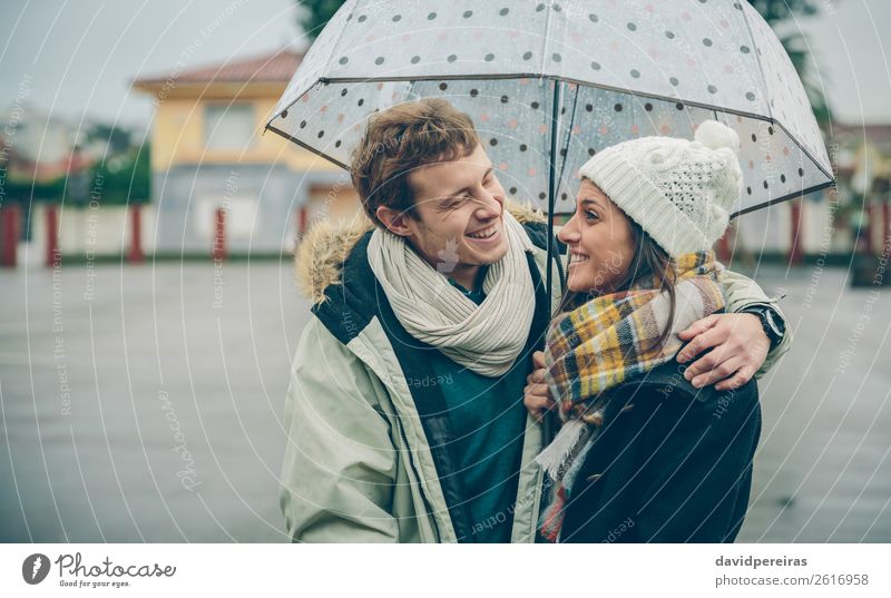 Couple embracing and laughing under umbrella in a rainy day Lifestyle Happy Beautiful Winter Human being Woman Adults Man Family & Relations Autumn Rain Street
