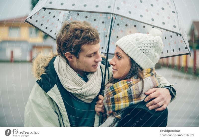 Young couple embracing under umbrella in an autumn rainy day Lifestyle Happy Beautiful Winter Human being Woman Adults Man Family & Relations Couple Autumn Rain