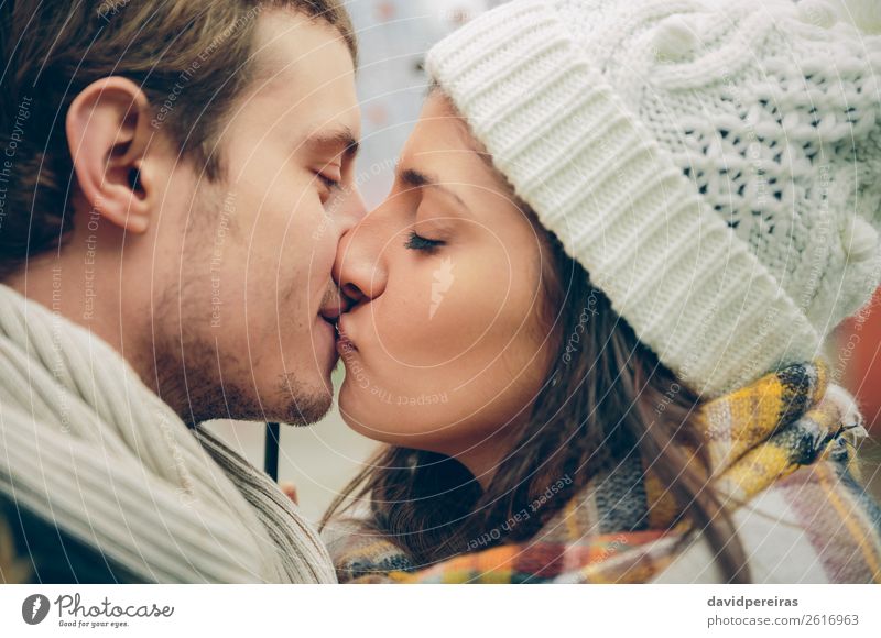 Young couple kissing in autumn rainy day Lifestyle Beautiful Winter Human being Woman Adults Man Family & Relations Couple Lips Autumn Scarf Hat Kissing Love