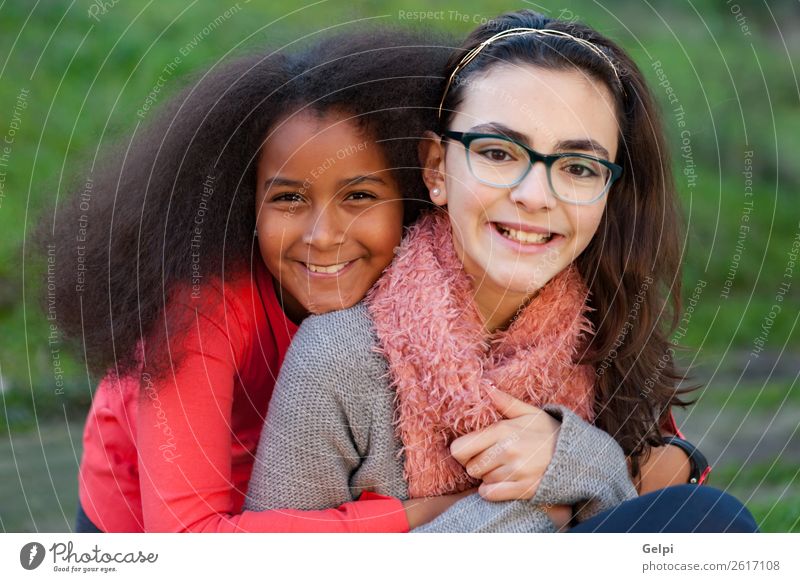 Two happy girls friends Joy Happy Beautiful Face Winter Garden Child Human being Family & Relations Friendship Infancy Park Scarf Afro Smiling Happiness