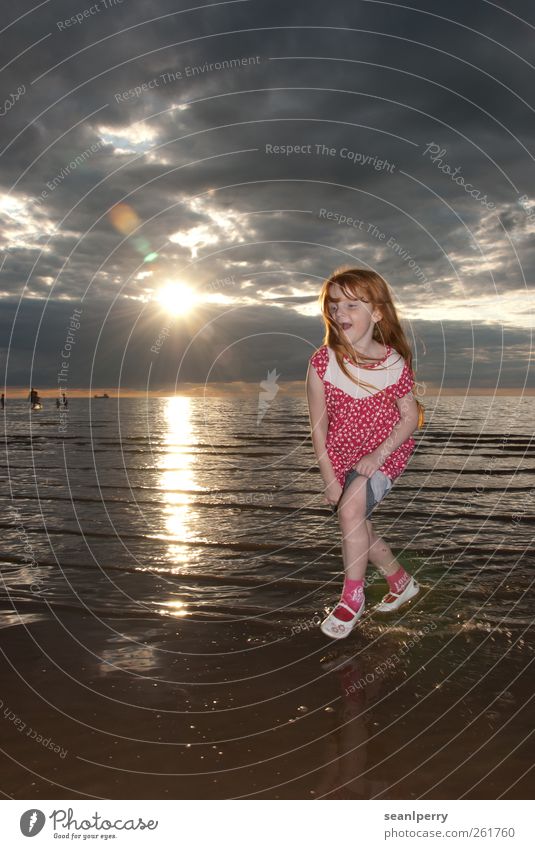 Sunset Paddling Joy Summer vacation Beach Ocean Child Girl 1 Human being 3 - 8 years Infancy Clouds Coast Rolled up Red-haired Laughter Running Happy Pink