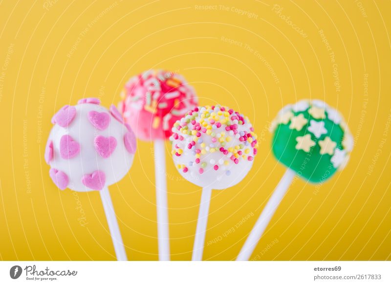 Sweet cake pops on yellow background Baked goods Cake Candy Colour Multicoloured Food Food photograph Lollipop Baking Yellow Dog food Stick Pink Dessert Bright