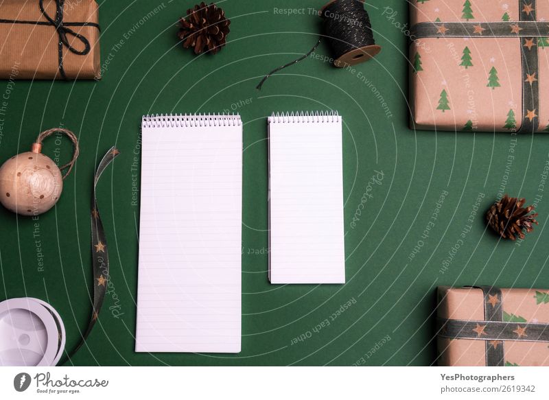 Empty notebooks surrounded by gifts Elegant Happy Winter Decoration Desk Table Christmas & Advent String Brown above view Blank christmas christmassy Classic