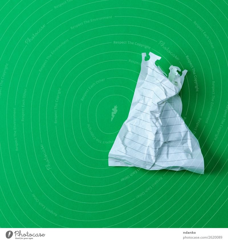 wrinkled white sheet torn from a notepad on a green background Office Paper Green White Colour Idea Stress crumpled page Document garbage Consistency