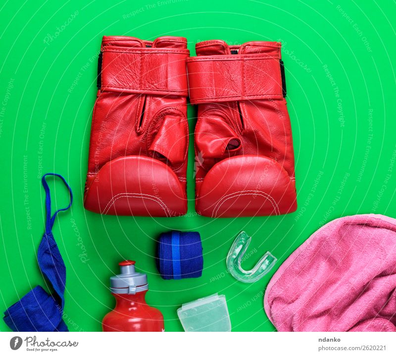 red leather boxing gloves, a plastic water bottle Bottle Fitness Sports Success Leather Gloves Above Blue Green Pink Red Might Protection Idea Competition