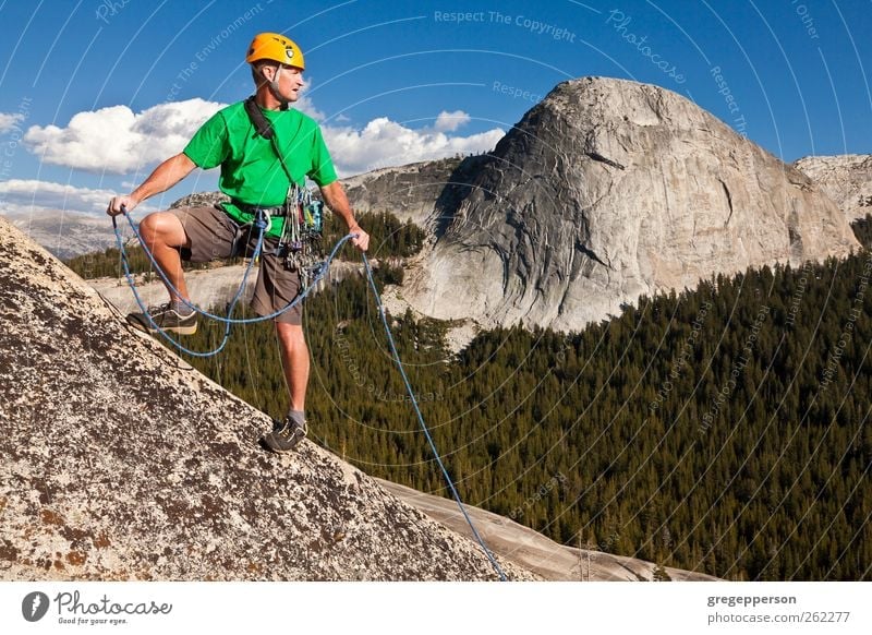 Climber conquering the summit. Life Adventure Hiking Climbing Mountaineering Success Rope Man Adults 1 Human being 30 - 45 years Nature Rock Peak Helmet