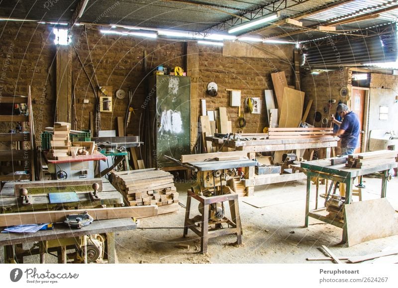 Man doing woodwork in carpentry. Carpentry workshop - a Royalty