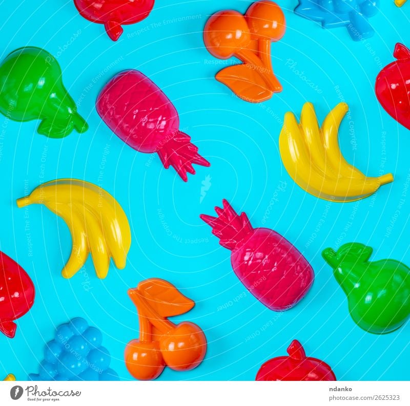 blue background with childrens colorful toys Fruit Joy Leisure and hobbies Playing Child Toys Plastic Small Cute Yellow Green Pink Red Colour Idea flat food