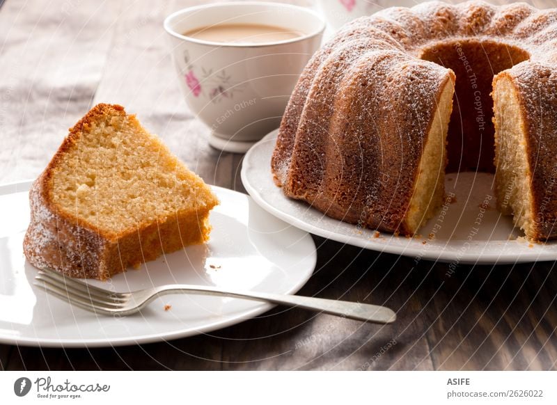 Sponge cake with coffee with milk Yoghurt Dessert Breakfast Coffee Tea Plate Fork Table Wood Fresh Juicy Brown Tradition bundt bundt cake Baking food Home-made