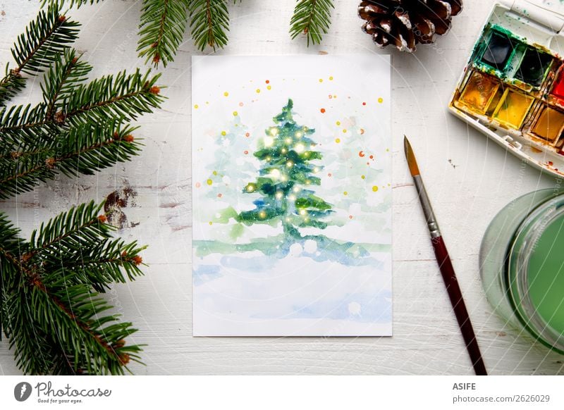 Painting a watercolour Christmas card Design Leisure and hobbies Handcrafts Snow Decoration Table Craft (trade) Tree Paper Wood White Creativity Tradition fir