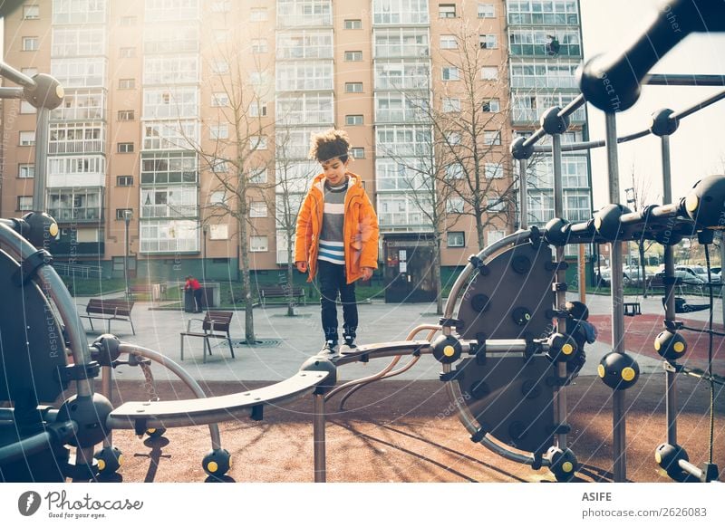 Little boy playing in the balance bar in a playground Joy Happy Leisure and hobbies Playing Winter Climbing Mountaineering Child Boy (child) Man Adults Infancy