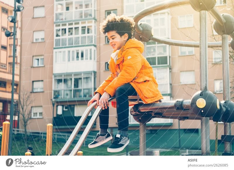Happy little boy having fun in an urban playground Joy Leisure and hobbies Playing Winter Climbing Mountaineering Child Boy (child) Man Adults Infancy Autumn