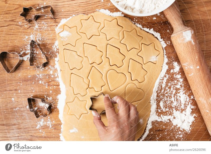 Making Christmas cookies Dough Baked goods Table Christmas & Advent Tree Wood Metal Heart Make Cookie Flour Rolling pin cutters cookie cutter Cut star cooking