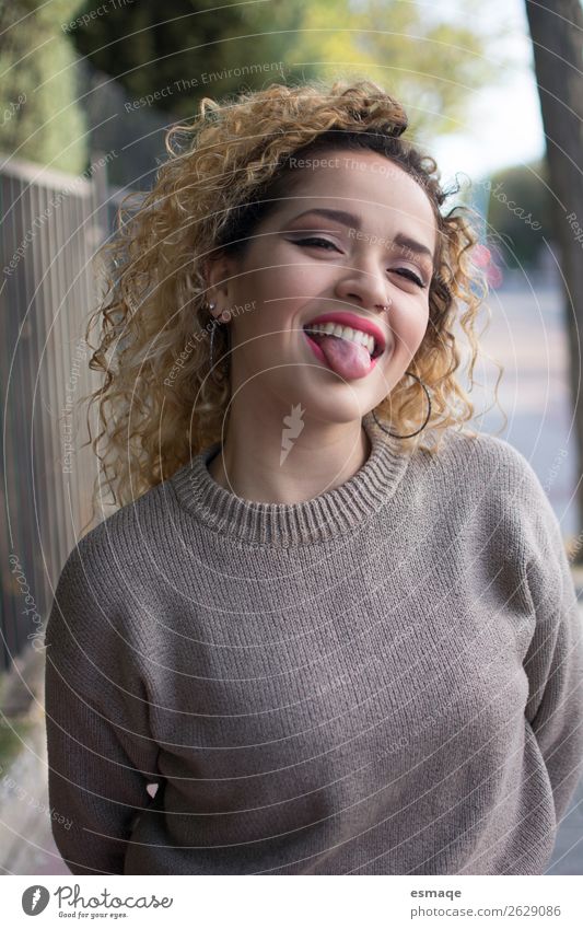 Portrait of young and funny woman sticking out her tongue - a Royalty Free  Stock Photo from Photocase