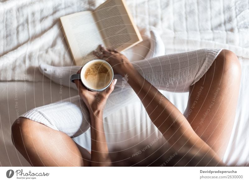 Cropped view of woman putting her feet in warm comfy socks on windowsill  with book and coffee, closeup Stock Photo - Alamy