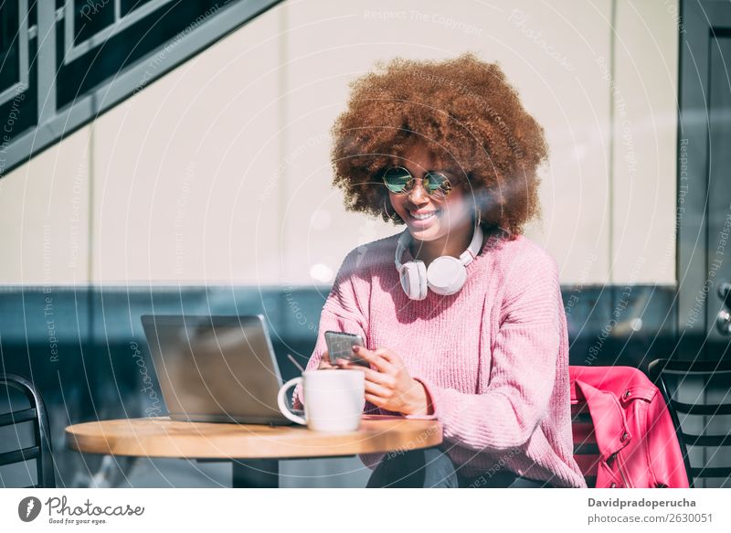 Mixed race woman in a coffee shop with mobile phone Woman Adults Black African-American Lifestyle Mobile Telephone PDA Communication Work and employment Curly