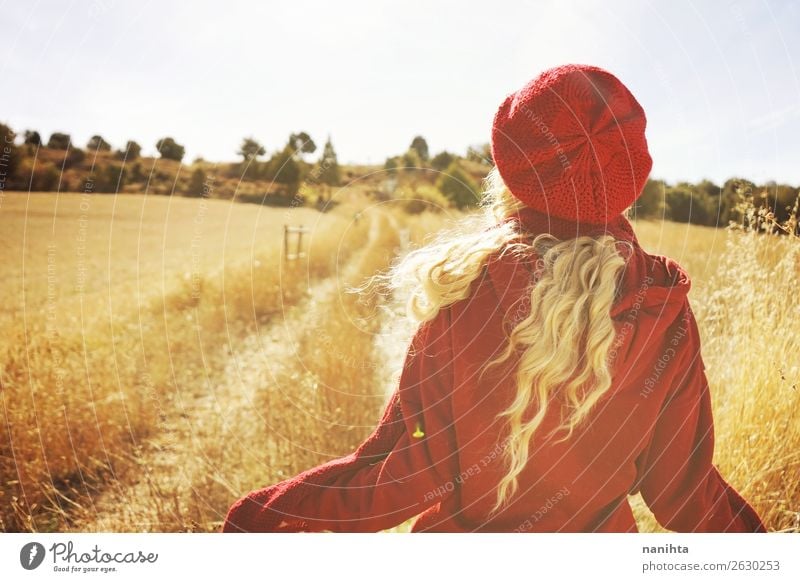 Back view of a young blonde woman in nature Lifestyle Style Joy Hair and hairstyles Healthy Wellness Senses Relaxation Adventure Freedom Sun Human being